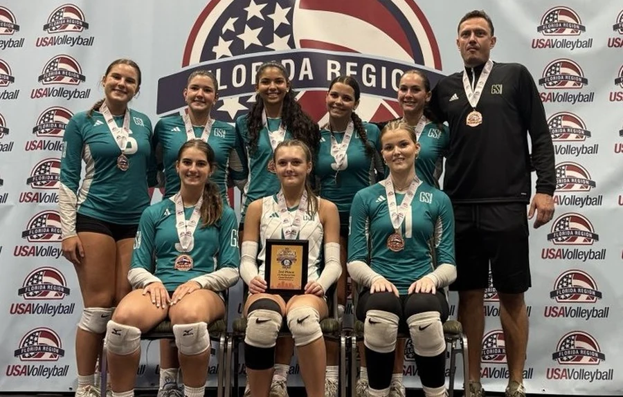 GSI Academy student-athletes holding medals and a program award