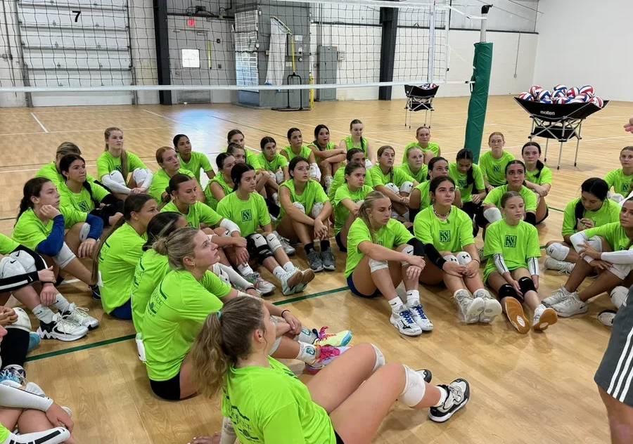 Volleyball campers and coaches gathered inside GSI