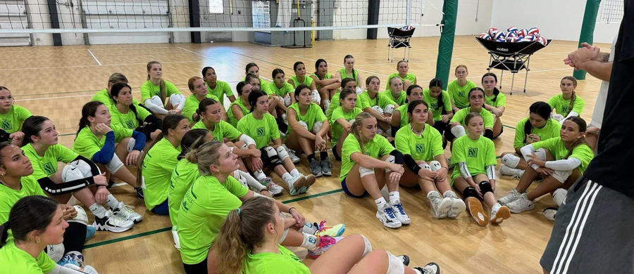 Volleyball athletes receiving instruction during a clinic