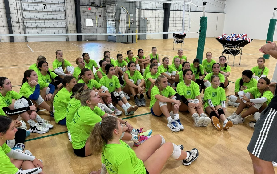 Volleyball campers gathered with coaches at GSI