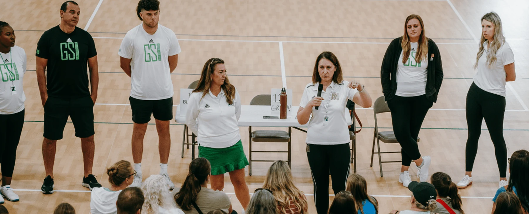 GSI coaches speaking with athletes during a team briefing