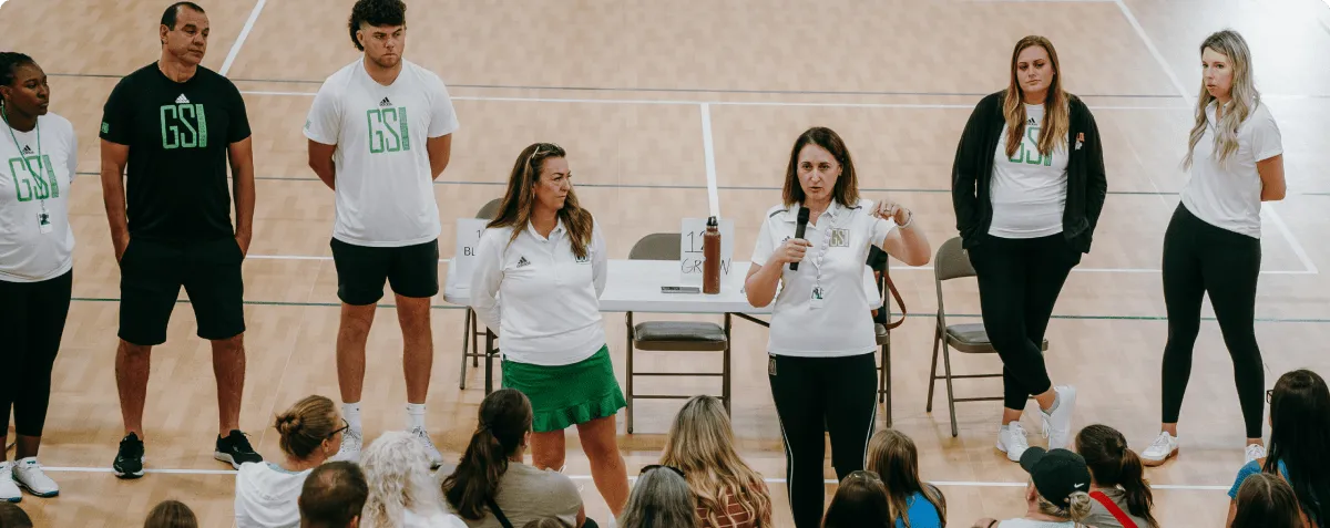 Athletes and coaches meeting on a GSI indoor court